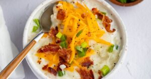 Bowl of Potato Soup with Cheddar Cheese, Bacon and Green Onions
