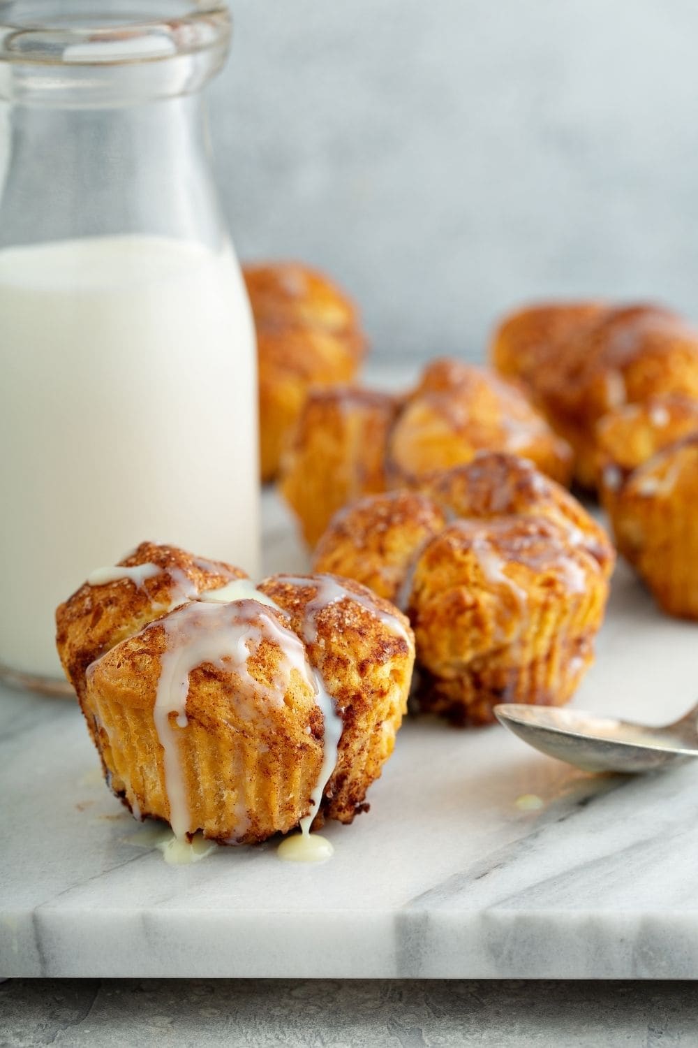 Cinnamon muffins drizzled with sugar glaze. 