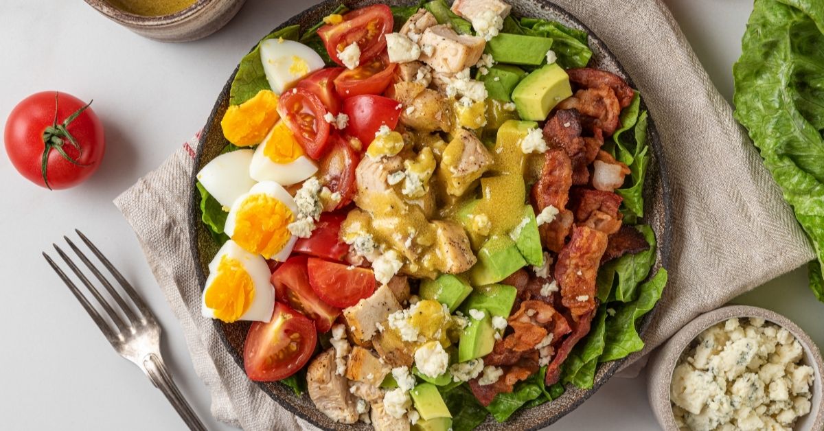 Classic American Cobb Salad with Tomatoes, Avocados, Eggs, Chicken and Bacons