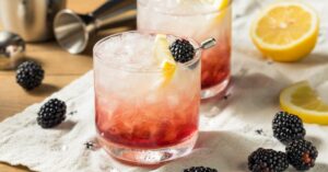 Cold Gin Bramble Cocktails with Blackberries and Lemons