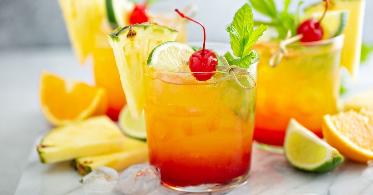 Cold Tequila Sunrise with Fresh Cherries, Lime and Pineapple