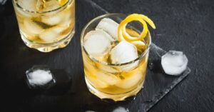 Cold Whiskey Cocktail with Lemon Peel and Ice