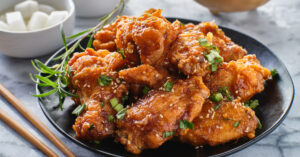 Homemade Crispy Fried Korean Chicken Wings with Sesame Seeds and Green Onions