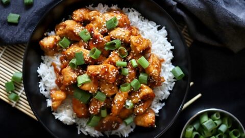 Homemade Glazed Chicken with Rice in a Black Plate