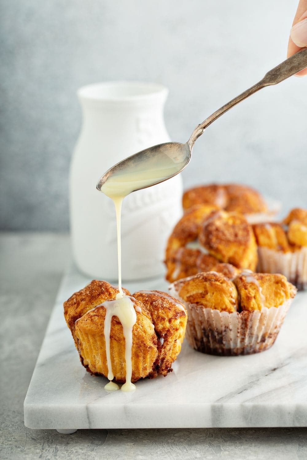 Milk drizzled on top of Monkey Bread Muffins. 