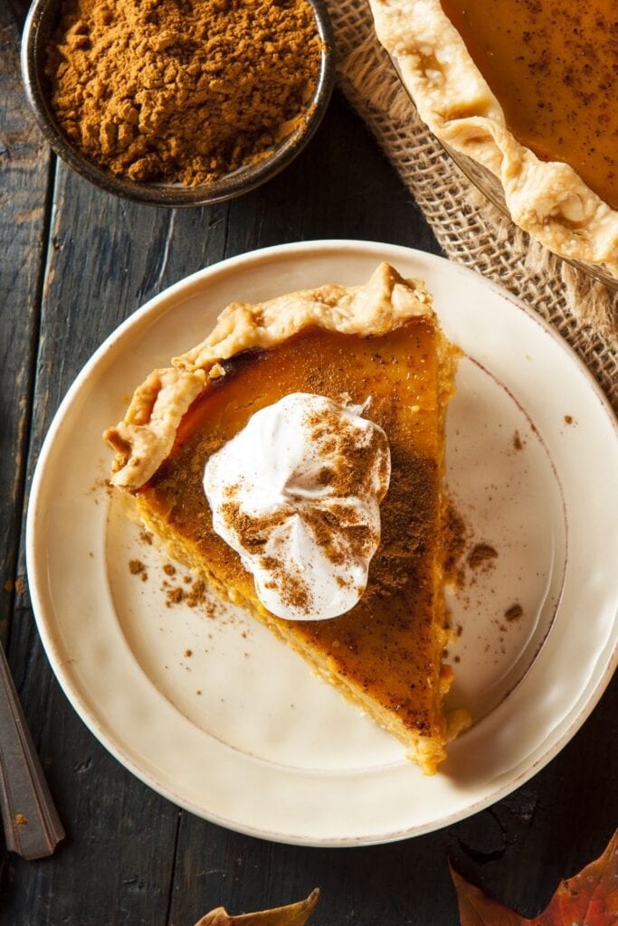 Pumpkin Pie with Whipped Cream and Cinnamon