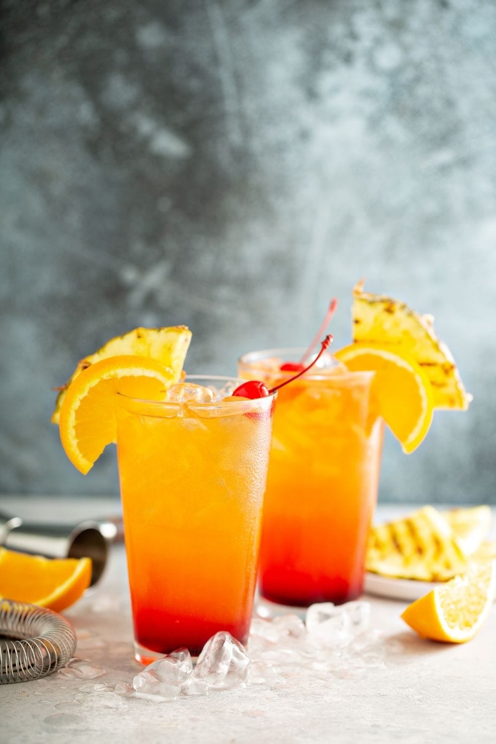 Refreshing Tequila Sunrise with Fresh Pineapple, Orange and Cherry