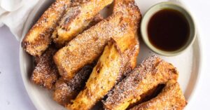 Soft and Crispy Homemade French Toast Sticks with Powdered Sugar and Sauce