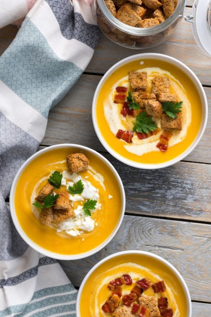 Warm Butternut Squash Soup with Croutons and Bacon Bits