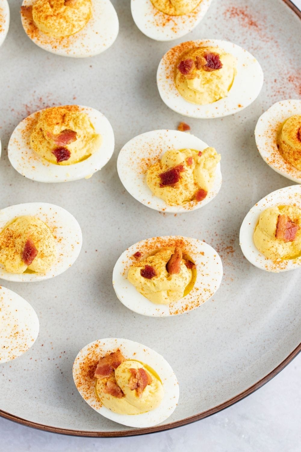 Bunch of Deviled Eggs garnished with paprika powder served on a plate