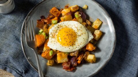 Homemade Sweet Potato Hash with Egg and Bacon in a Plate