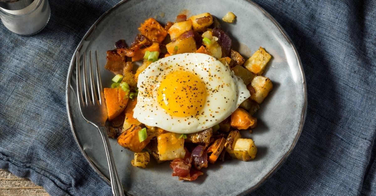 Homemade Sweet Potato Hash with Egg and Bacon in a Plate