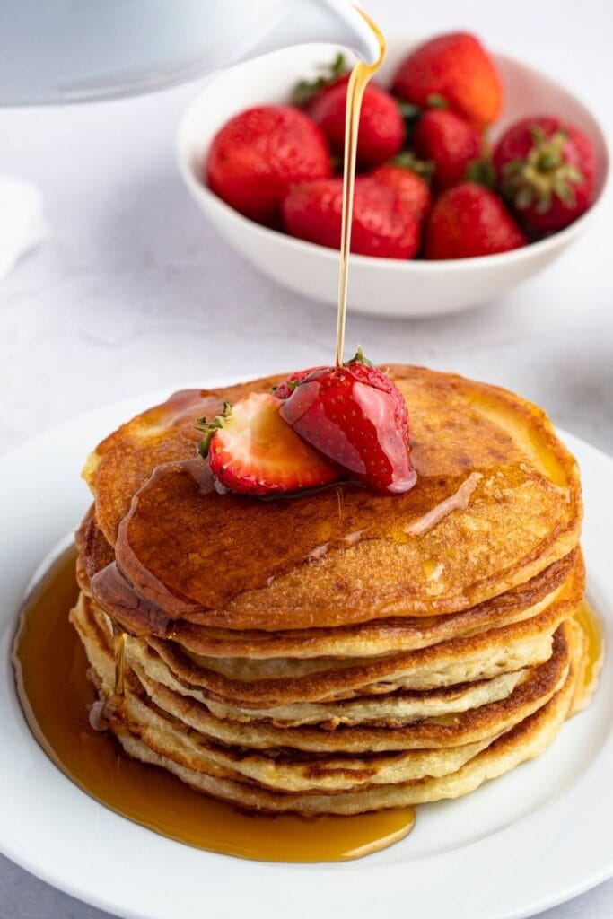 Pancakes Topped with Strawberries and Syrup