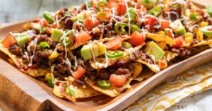 Spicy Loaded Nachos with Tomatoes Jalapenos and Avocados