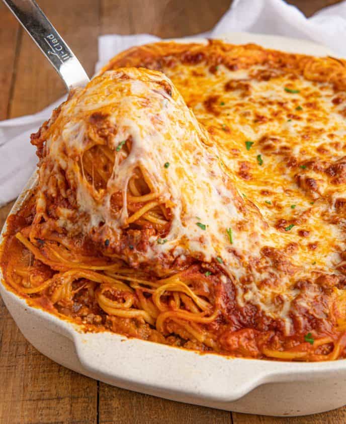 Baked spaghetti is a family favorite with layers of cheese, ground beef, and spaghetti noodles all in a quick and easy marinara sauce.