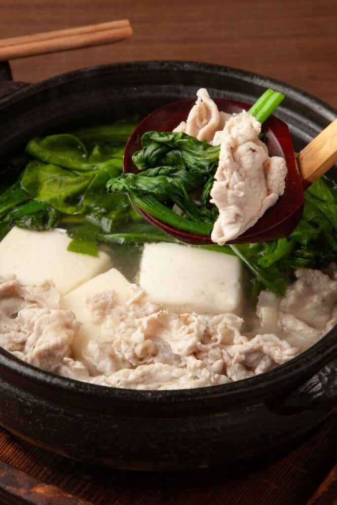 Best Japanese tofu recipes including Yudofu, boiled tofu with spinach in a bowl.