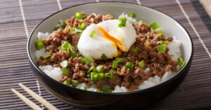 Bowl of Spicy Japanese Ground Beef with Poached Egg, Green Onions and Rice