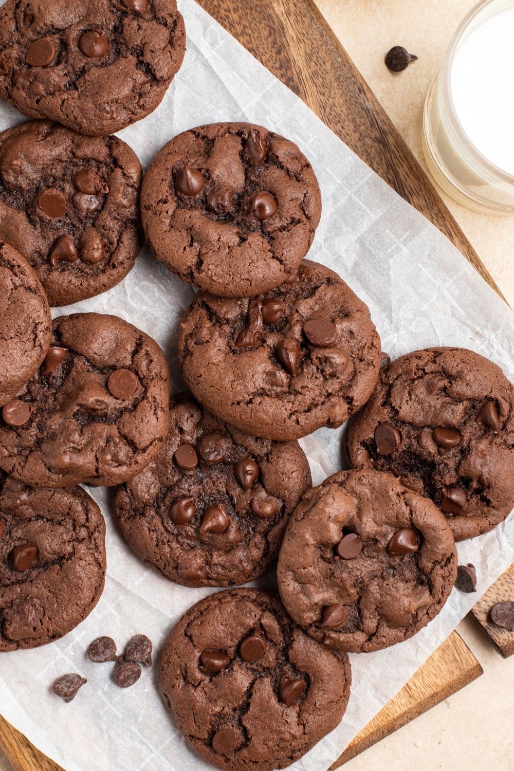 Chocolate Cake Mix Cookies Recipe (So Easy!) featuring Chocolate Cake Mix Cookies  on Parchment with a Glass of Milk