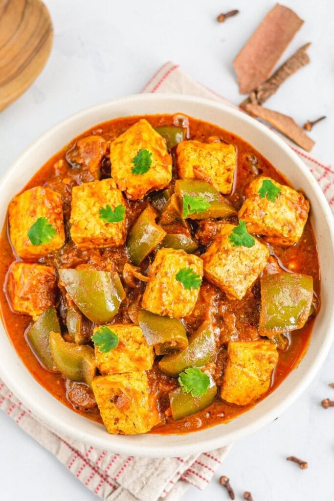 Indian tofu recipes featuring tofu and bell pepper curry in a bowl