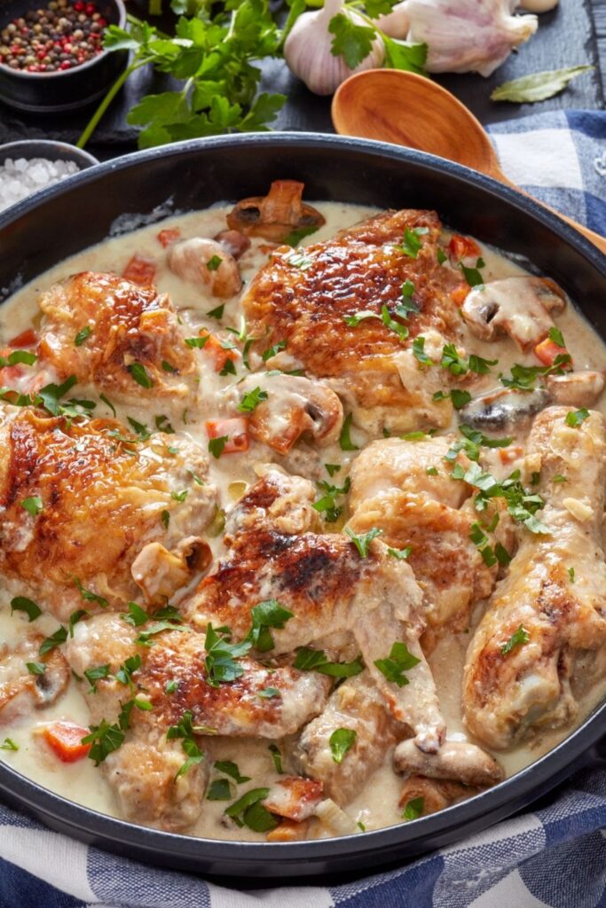 Best French Chicken Recipes. Photo shows French creamy stewed chicken in a skillet on a table
