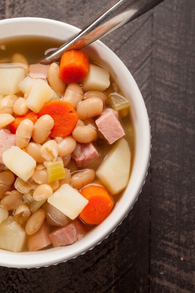 Hearty Homemade Ham and Beans Soup with Carrots in a bowl