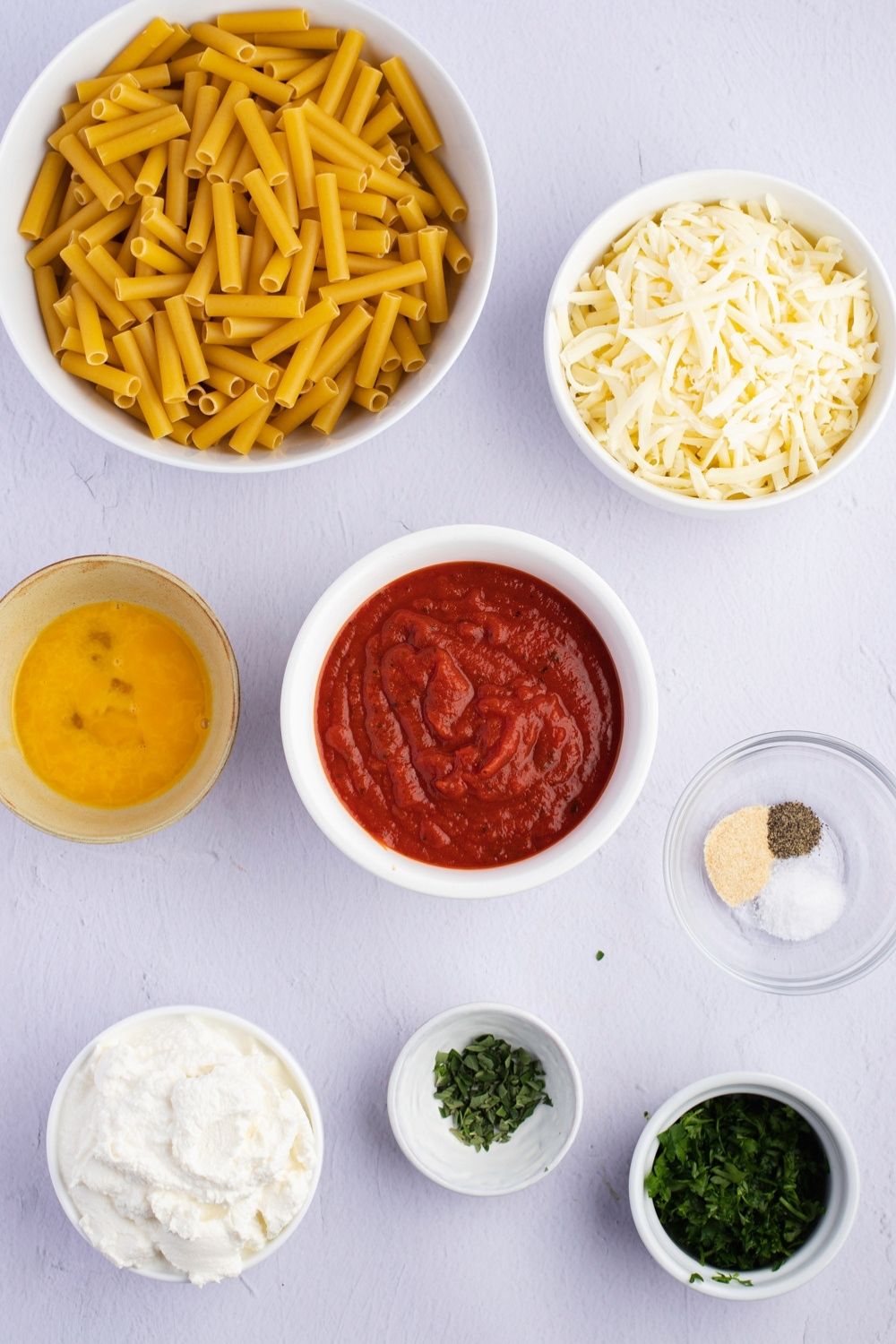 Meatless Baked Ziti Ingredients: Ziti, Pasta Sauce, Ricotta, Mozzarella, Parmesan, Egg, Parsely, Oregano and Garlic Powder