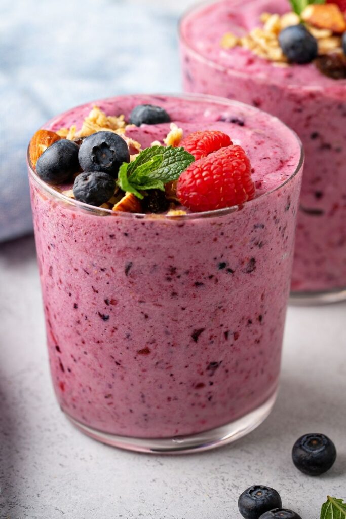 Top 10 Blendjet recipes and Blendjet smoothie ideas. Photo shows a mixed berry smoothie with fresh berries in a small glass.