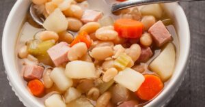Old-Fashioned Ham and Beans Soup with Carrots in a Bowl