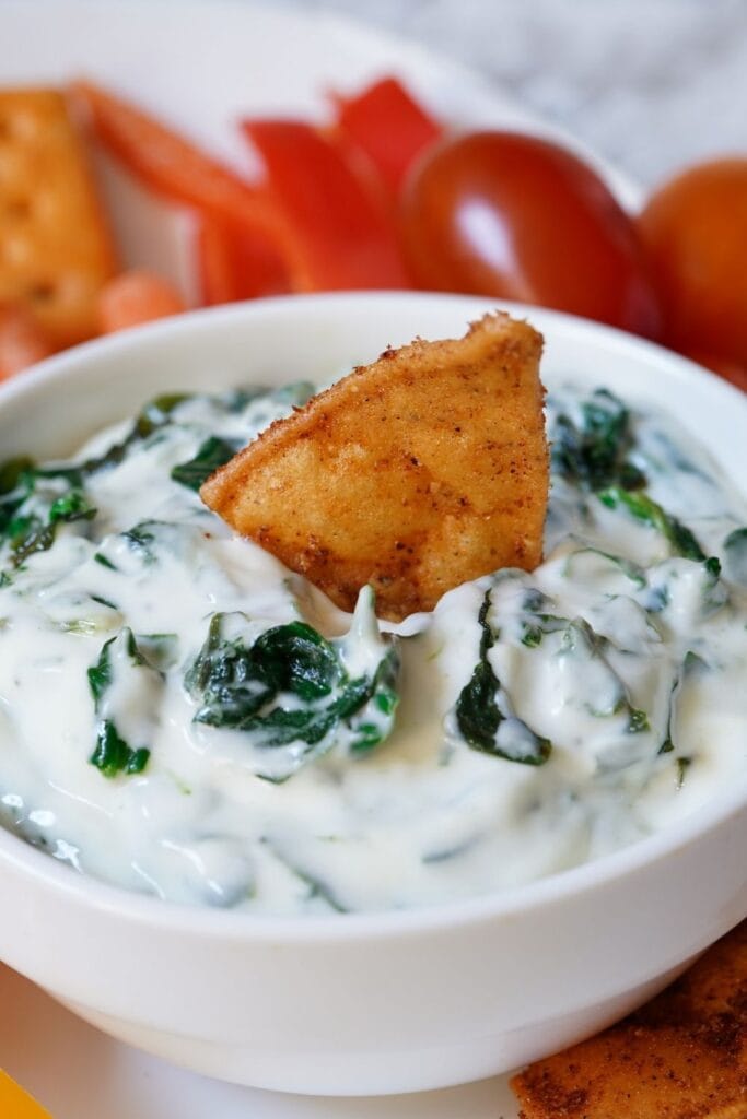 Spinach Dip with a Cracker in a Bowl