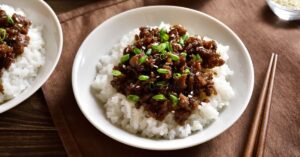 A Bowl of Ground Beef and Rice with Chopped Onions
