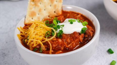 Bowl of Homemade Ground Turkey Chili with Cheese and Crackers