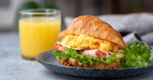 Delicious Homemade Croissant Sandwich with Ham and Scrambled Eggs