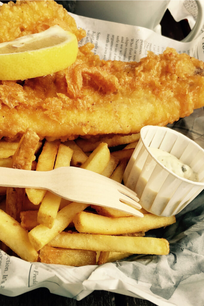 Fish and Chips on a newspaper with lemon and tartar sauce