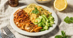 Homemade Chicken Harissa with Couscous and Cucumber in a Plate