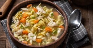 Homemade Chicken Noodle Soup with Carrots in a Bowl