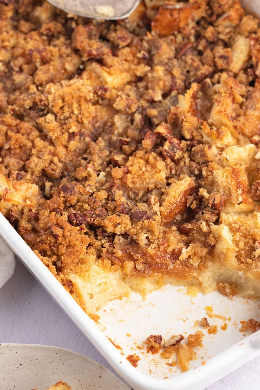 Closeup of Homemade Paula Deen Bread Pudding in a Casserole Dish with Some Bread Pudding Missing