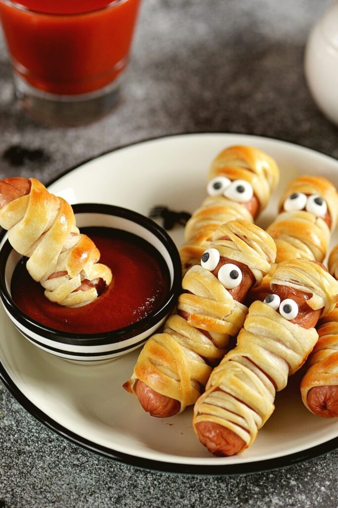 25 Scary-Easy Halloween Breakfast Recipes featuring Homemade Sausage Mummies with Ketchup
