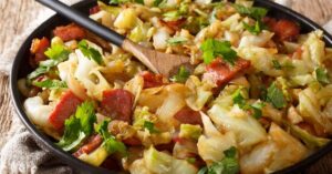 Homemade Stir-Fry Cabbage with Bacon in a Black Plate