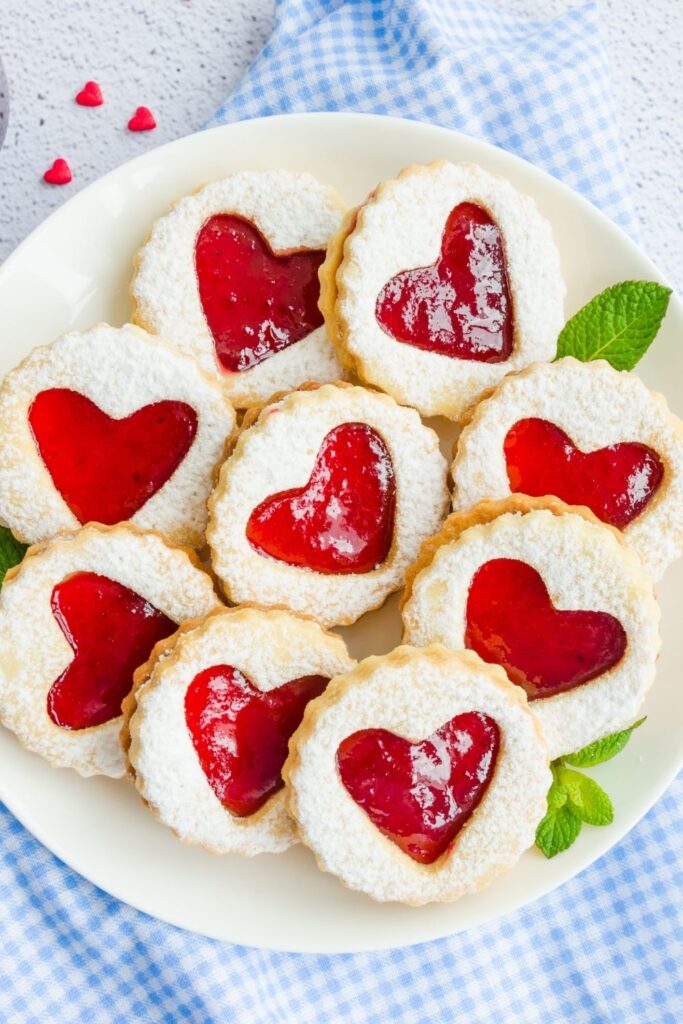 33 Easy Vegan Christmas Desserts 
 including Homemade Vegan Linzer Cookies served on a plate
