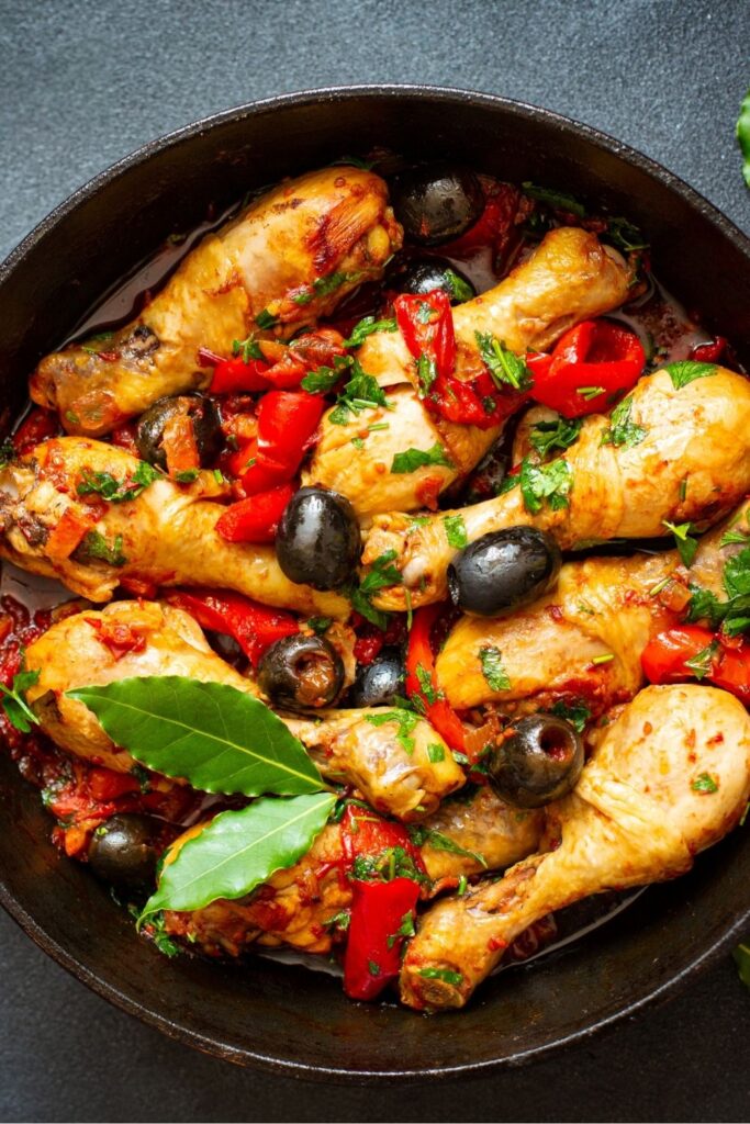 Easy One-Pot Chicken Dinner Recipes. Photo shows Italian Chicken Dinner with Olives and Peppers served in a cast-iron skillet