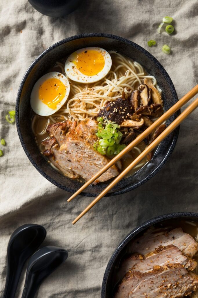 23 Easy Homemade Ramen Recipes featuring Japanese Pork Ramen with Eggs and Mushrooms served in a bowl with chopsticks