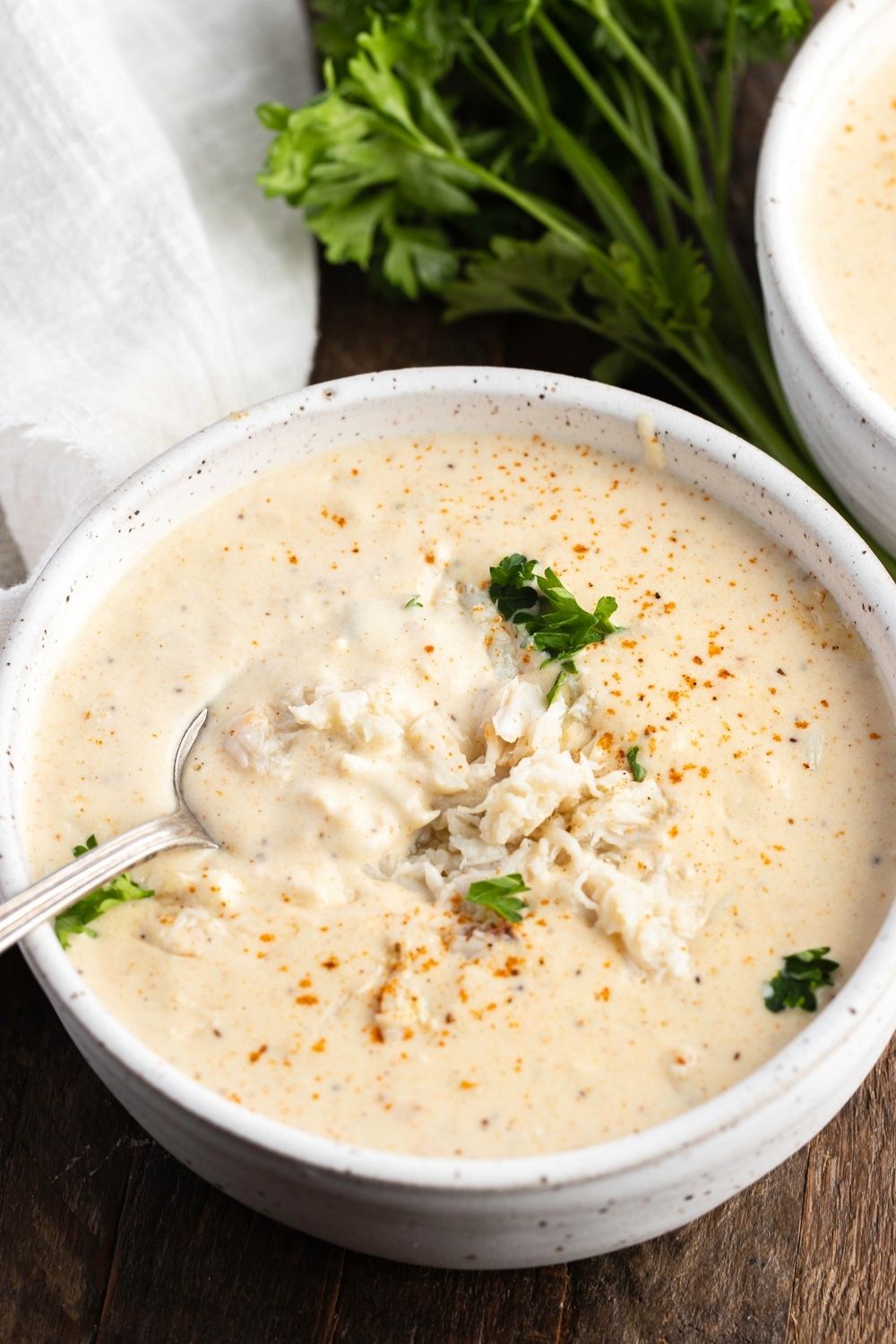 Rich and Creamy Cream of Crab Soup in a Wooden Board
