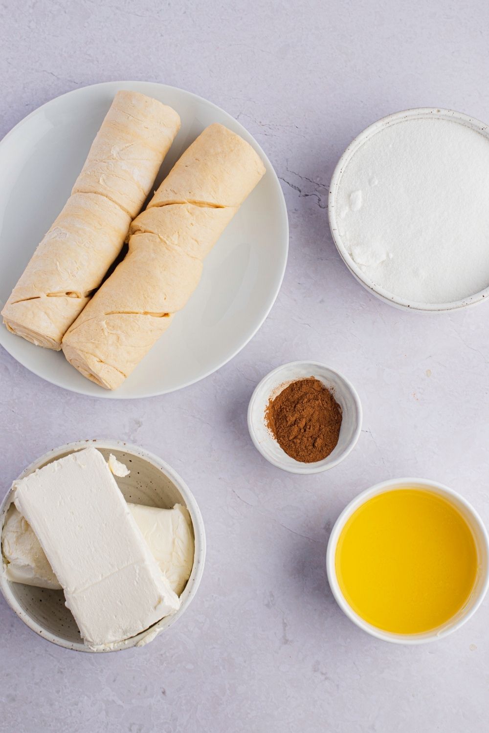 Sopapilla Cheesecake Bar Ingredients: Crescent Roll Dough, Cream Cheese, Sugar, Vanilla, Butter and Ground Cinnamon