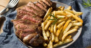 Steak with Rosemary, Fries and Salt in a Plate