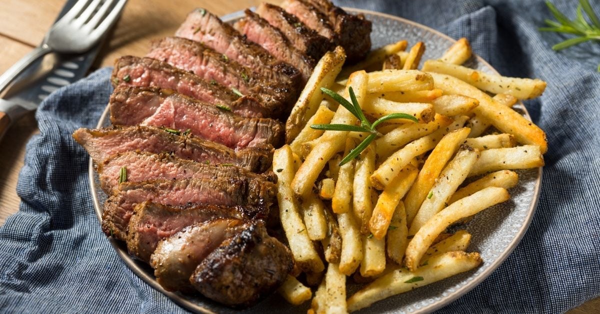 Steak with Rosemary, Fries and Salt in a Plate