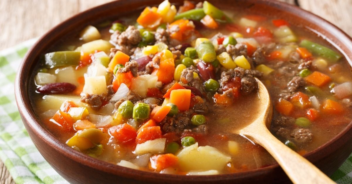 Warm Homemade Beef and Vegetable Soup with Carrots, Peas, Corn and Beans