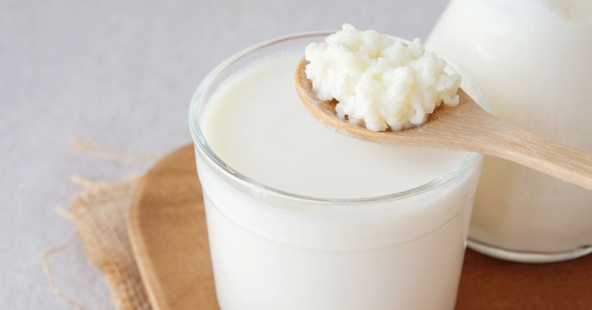 https://insanelygoodrecipes.com/wp-content/uploads/2022/03/A-Glass-of-Kefir-Milk-with-A-Spoon-of-Kefir-Grains.jpg