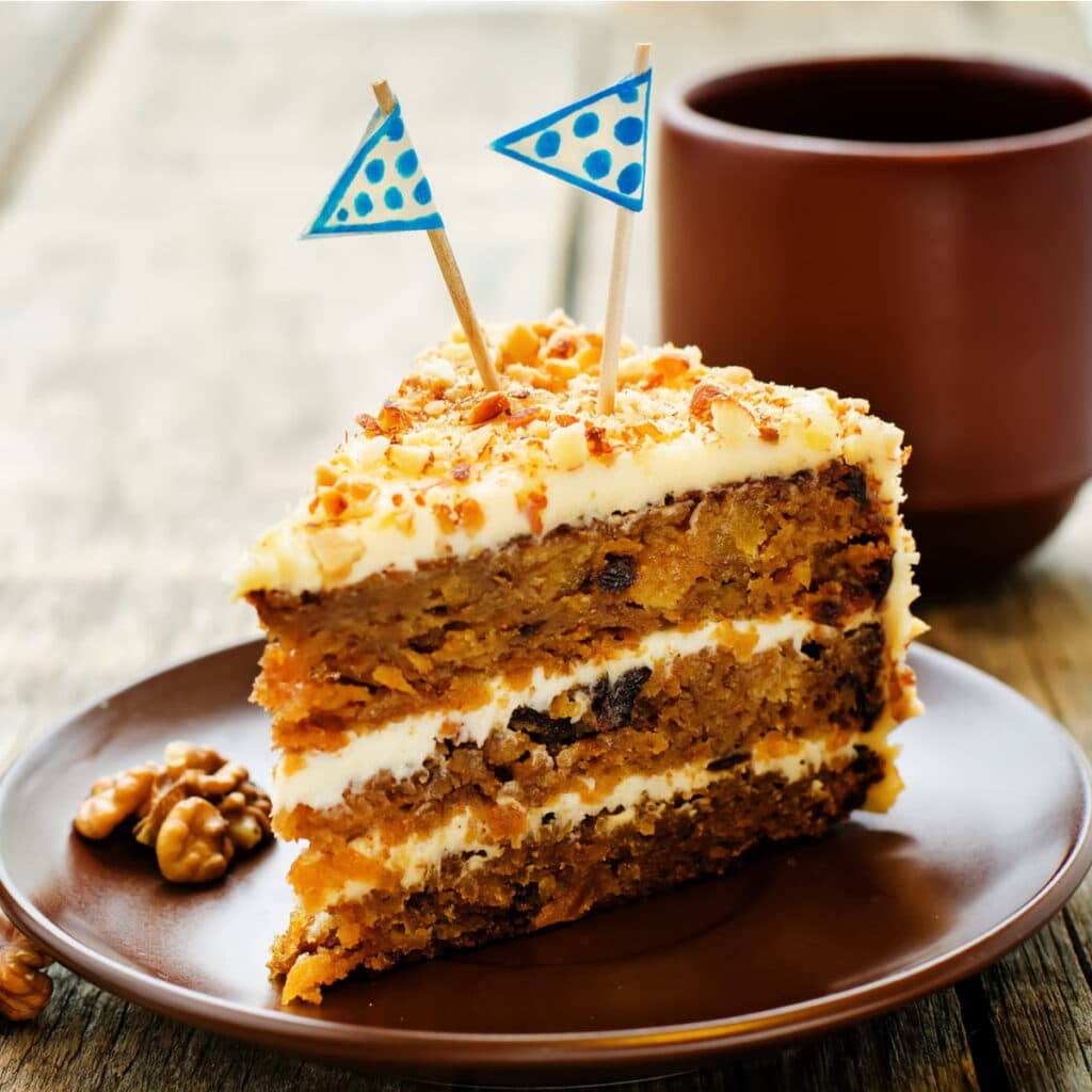 A Slice of Carrot Cake with Nuts in a Plate