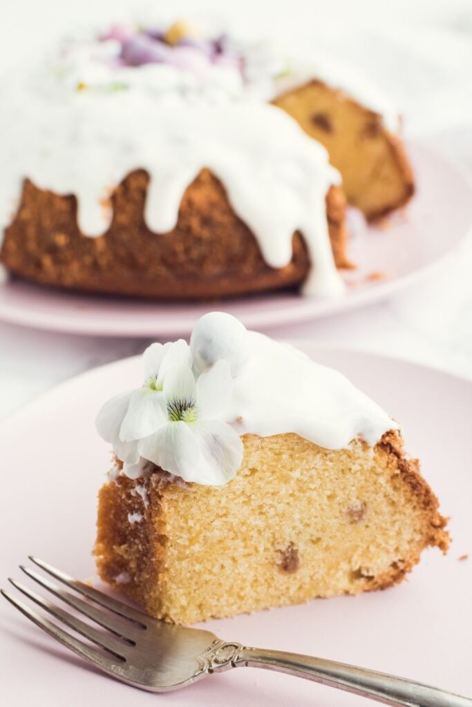 30 Easter Cakes for a Hoppin’ Good Time. Photo shows A Slice of Easter Bundt Cake with Vanilla Icing