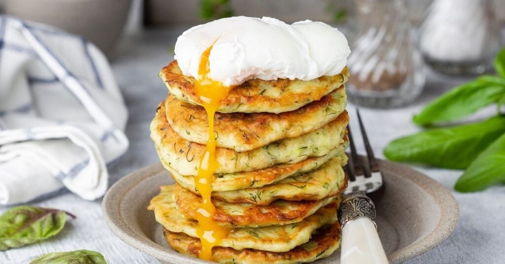 17 Healthy Zucchini Appetizers Insanely Good   A Stack Of Zucchini Fritter With Poached Egg 1024x536 